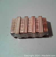 Top view of the wooden puzzle box wrapped in shrink plastic.