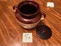 Photo of the ceramic cookie jar without lid, showing the interior and two side handles, with a glossy brown top and matte beige bottom.