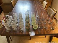 Wide shot of three sets of glasses on a wooden table showing the layout and quantity