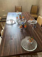 Overview of the glassware and serving bowls on the dining table, showing the complete set with glasses and bowls.