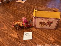 Photo showing the Sicilian cart and horse with the original box on a wooden table.