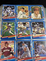 Photo showing multiple 1990-91 Donruss baseball cards including Randy Johnson, Dave Dravecky, and Roberto Alomar with blue borders and gold Diamond Kings inserts.