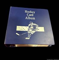 Blue hardcover hockey card album with title and hockey player graphic on front cover