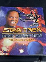 Binder cover showing Star Trek Deep Space Nine trading cards featuring character and spaceship graphics.
