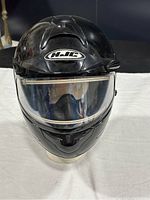 Front view of black HJC CL-16 full face snow helmet with clear visor.