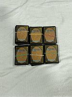 Six bundles of Magic: The Gathering cards secured with rubber bands, showing card backs.
