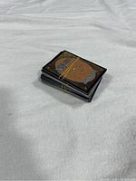 Stack of Magic: The Gathering cards showing the brown and orange card backs with the Magic logo.