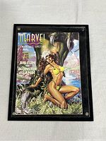 Framed front cover of Marvel Swimsuit Special magazine showing a woman in a yellow bikini with monster claw and tropical island