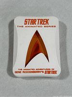 White Star Trek DVD box featuring gold Starfleet insignia and orange text on front