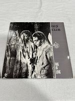 Front cover of Fire Of Love vinyl record by The Gun Club, black and white artistic photo of band members.