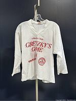 Front view of the white signed vintage woman's hockey jersey with red Gretzky's Game and Spalding logos.