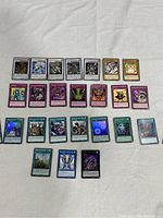 Full view of the 24 Yu-Gi-Oh! cards laid out in rows showing the card artwork and card types.
