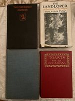 Four hardcover books displayed open top view showing covers and dust jackets.