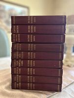 Stack of nine maroon hardcover books authored by Richard Harding Davis with gilt lettering on spines.