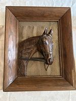 Full view of the vintage horse head relief framed in wood with metal mesh background showing overall condition and size.