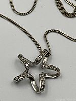 Star-shaped pendant with pave diamonds on a flat white background