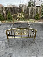 Full view of brass bed frame showing headboard, footboard, and side rails