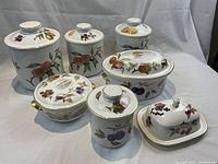 Seven-piece set of jars and serving dishes arranged on white backdrop