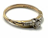 Side profile view of ring showing yellow gold band, engraved heart motif and white gold head with diamond.
