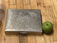 Top view of closed box with apple for scale