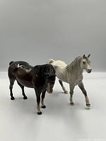 Front angle of both horse figurines showing profiles