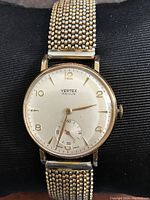 Front view of watch showing dial, hands and mesh band