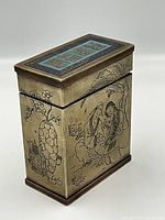 Front and side view of box showing enamel lid and etched scene of two figures under a tree
