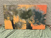 Front view of the large giclee printed canvas showing dark tree silhouettes against an orange sky, signed and numbered by the artist.