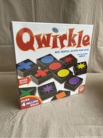 Front of the sealed Qwirkle game box showing colorful wooden tiles and branding.
