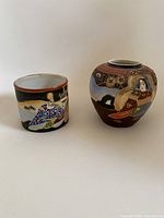 Photo showing both vases side by side, highlighting the contrasting shapes and artistic styles.