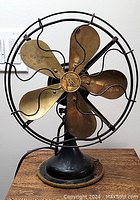 Front view of fan showing overall structure, base, blades and wire cage