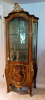 Full front view of ormolu-mounted painted vitrine cabinet