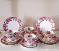 Complete set of cups, saucers, and plates showing floral pink rose design and gold trim