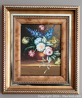 Frontal photo of the framed oil painting showing the floral arrangement and frame details.