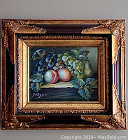 Full view of framed oil on canvas painting showing fruit still life and signature