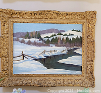 Full view of the framed winter landscape painting hung on wall