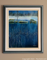 Framed oil on canvas painting showing a marshland scene with water, grasses, and a tree under a blue sky.
