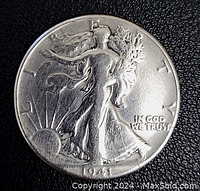 Obverse side photo showing Walking Liberty with sun rising in background and inscription IN GOD WE TRUST, year 1941 visible.