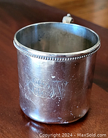 Front view of sterling silver cup showing monogrammed initials and beaded rim detail