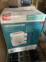 Photo of the TCL dehumidifier box showing product features and new condition.