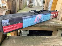 Close-up of the black carrying bag with Ventura branding, showing product name and features including removable side wall and quick setup montage illustrations.