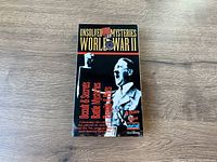 Front cover of Unsolved Mysteries World War II VHS tape showing cover art with historical figures and title text.