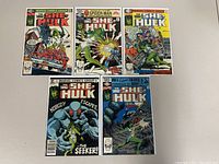 Five She-Hulk comic books laid out showing front covers with various issues of The Savage She-Hulk series.
