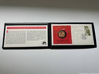 Overview of open presentation folder showing coin on display card with story text about the coin.