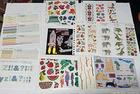 Multiple sticker sheets laid out flat on a surface showing different themes and designs