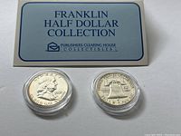 Front view of bi-fold presentation card labeled ‘Franklin Half Dollar Collection’ with two coins in clear plastic capsules