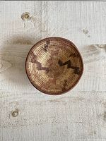 Top view of vintage woven boho coil basket showing tan and brown zigzag pattern