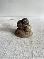 Front and left side view of mouse with strawberry stoneware sculpture