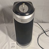 Front view of the silver and black Bionaire tower fan showing mesh grille and control panel