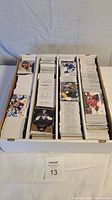 Box filled with stacks of hockey trading cards. Cards are mainly base cards, mostly newer than 1990s, in great condition.